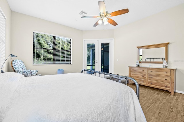 15420 27th Ct E, Parrish, FL 34219 - bedroom with french doors, wood finished floors, access to outside, and multiple windows