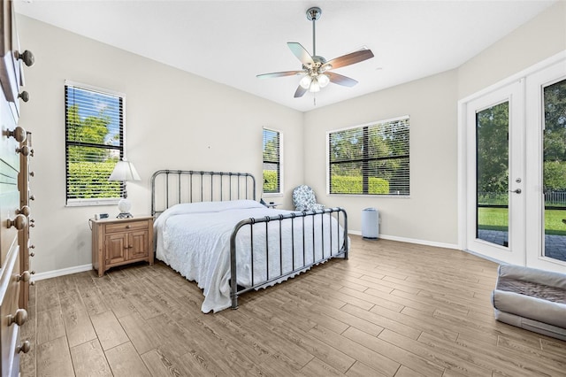15420 27th Ct E, Parrish, FL 34219 - bedroom with access to outside, light wood-style flooring, and a ceiling fan