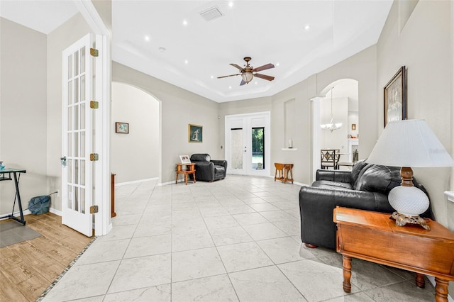 15420 27th Ct E, Parrish, FL 34219 - living room featuring arched walkways, french doors, a raised ceiling, a ceiling fan, and recessed lighting