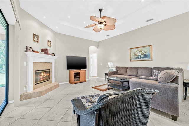 15420 27th Ct E, Parrish, FL 34219 - living area with a raised ceiling, a fireplace, ceiling fan, arched walkways, and recessed lighting