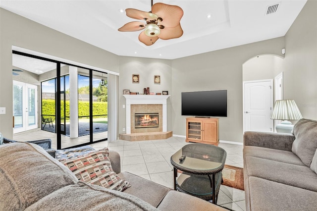15420 27th Ct E, Parrish, FL 34219 - living room featuring ceiling fan, light tile patterned flooring, a raised ceiling, a fireplace, and recessed lighting