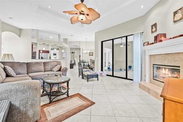 15420 27th Ct E, Parrish, FL 34219 - living area with arched walkways, a high end fireplace, ceiling fan, light tile patterned floors, and a chandelier