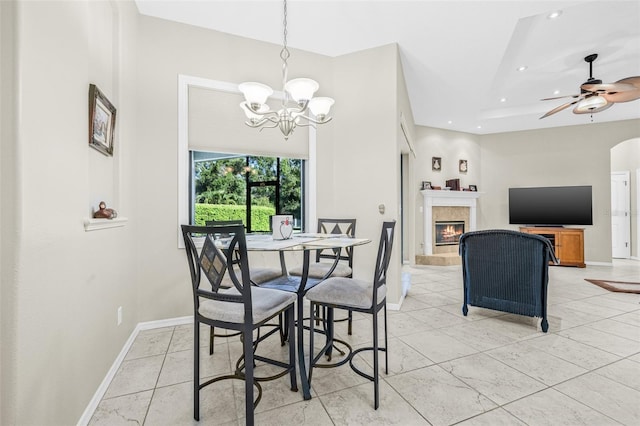 15420 27th Ct E, Parrish, FL 34219 - dining area with recessed lighting, a lit fireplace, a chandelier, light tile patterned floors, and ceiling fan