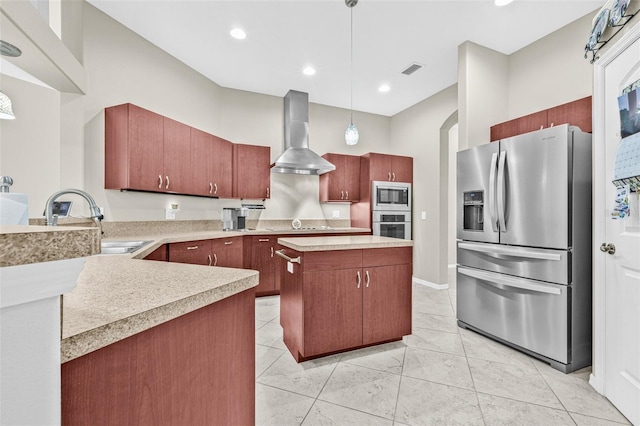 15420 27th Ct E, Parrish, FL 34219 - kitchen featuring stainless steel appliances, wall chimney exhaust hood, light countertops, decorative light fixtures, and a kitchen island