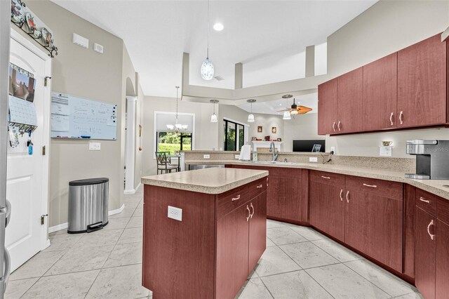 15420 27th Ct E, Parrish, FL 34219 - kitchen featuring light countertops, light tile patterned floors, a peninsula, and decorative light fixtures