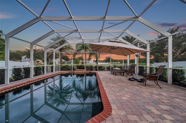 12424 White Bluff Rd, Hudson, FL 34669 - pool at dusk with a patio area, an outdoor pool, and glass enclosure