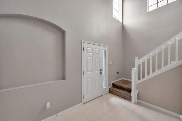 12424 White Bluff Rd, Hudson, FL 34669 - foyer featuring a towering ceiling, stairs, and tile patterned flooring