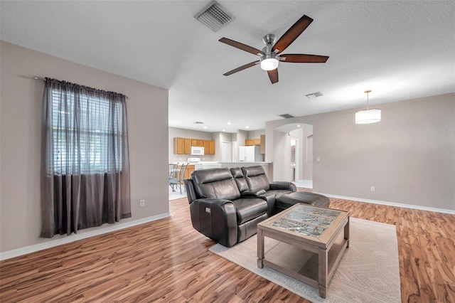 12424 White Bluff Rd, Hudson, FL 34669 - living room featuring ceiling fan, light wood-type flooring, and arched walkways