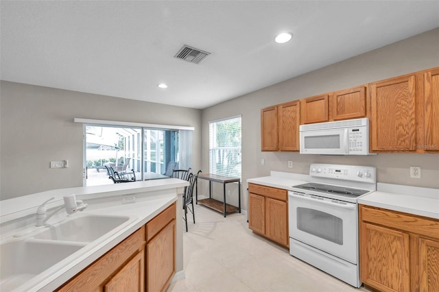 12424 White Bluff Rd, Hudson, FL 34669 - kitchen featuring white appliances, light countertops, recessed lighting, and light tile patterned floors