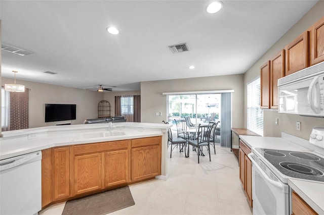 12424 White Bluff Rd, Hudson, FL 34669 - kitchen featuring white appliances, recessed lighting, light countertops, ceiling fan, and brown cabinets