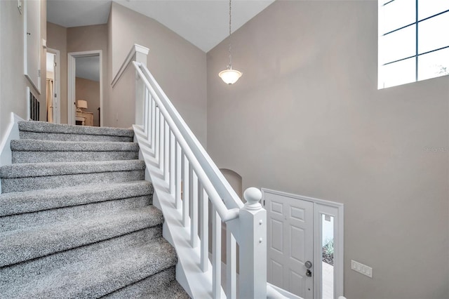 12424 White Bluff Rd, Hudson, FL 34669 - stairway featuring a towering ceiling