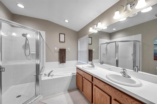 12424 White Bluff Rd, Hudson, FL 34669 - bathroom featuring double vanity, a stall shower, a bath, vaulted ceiling, and tile patterned flooring