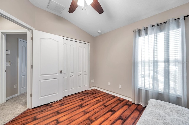 12424 White Bluff Rd, Hudson, FL 34669 - unfurnished bedroom featuring lofted ceiling, dark wood-style floors, a closet, and ceiling fan