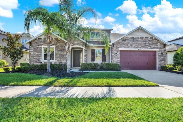 2120 Gwynhurst Blvd, Wesley Chapel, FL 33543 - view of front of house with stone siding, an attached garage, a front lawn, and concrete driveway