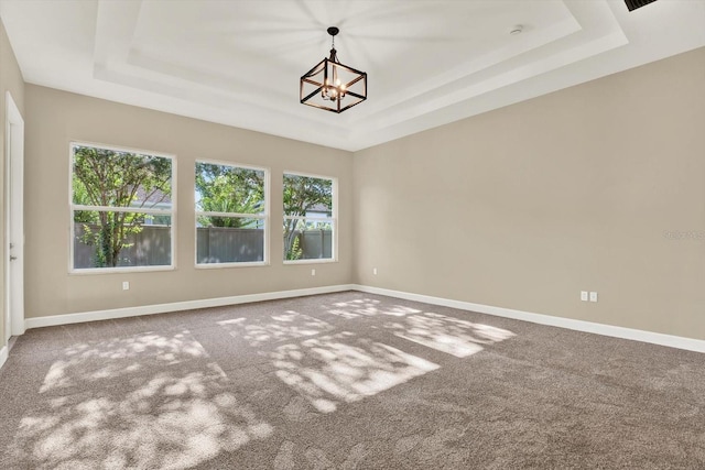 2120 Gwynhurst Blvd, Wesley Chapel, FL 33543 - carpeted spare room with a tray ceiling and a chandelier