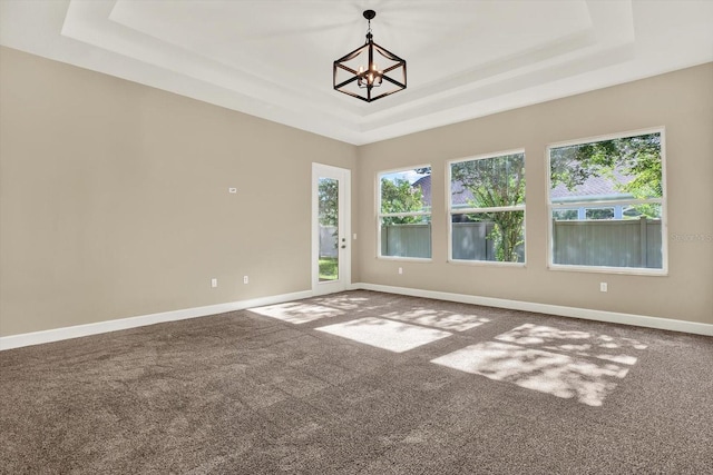 2120 Gwynhurst Blvd, Wesley Chapel, FL 33543 - carpeted spare room with a tray ceiling, a chandelier, and plenty of natural light
