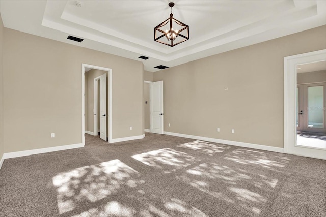 2120 Gwynhurst Blvd, Wesley Chapel, FL 33543 - carpeted spare room featuring a raised ceiling and a chandelier