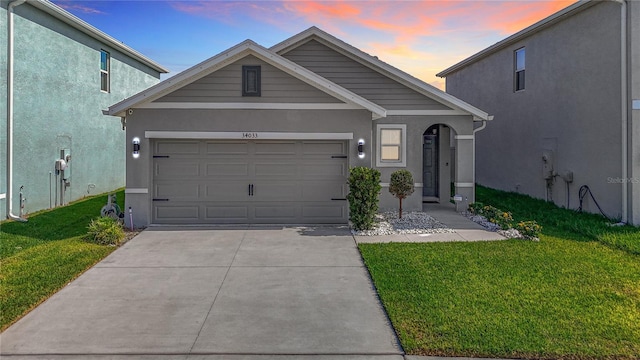 34033 Jasper Stone Dr, Wesley Chapel, FL 33543 - traditional home with stucco siding, a lawn, driveway, and an attached garage