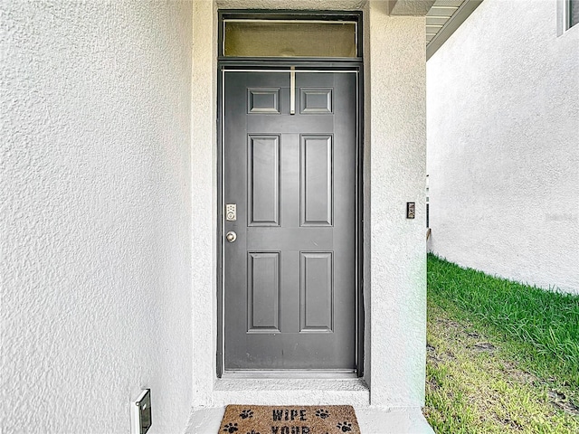 34033 Jasper Stone Dr, Wesley Chapel, FL 33543 - doorway to property with stucco siding
