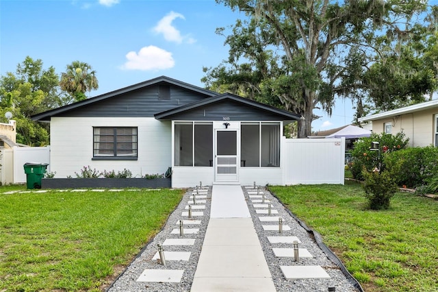 5055 9th St, Zephyrhills, FL 33542 - bungalow-style home featuring a sunroom