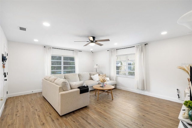 5055 9th St, Zephyrhills, FL 33542 - living area with light wood-style floors, ceiling fan, and recessed lighting