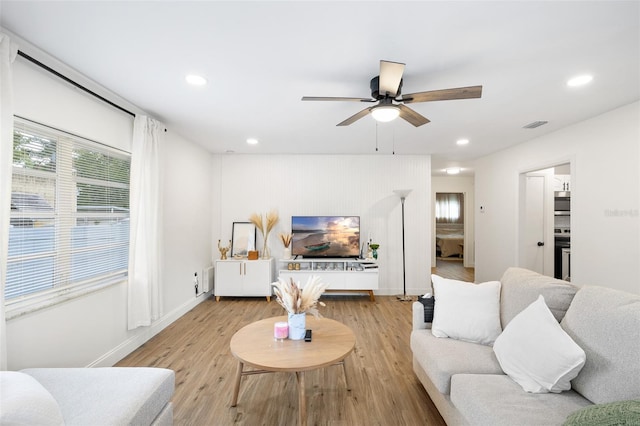 5055 9th St, Zephyrhills, FL 33542 - living room featuring ceiling fan, recessed lighting, and light wood-style flooring