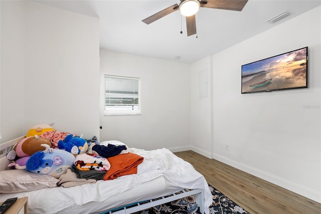 5055 9th St, Zephyrhills, FL 33542 - bedroom with wood finished floors and ceiling fan