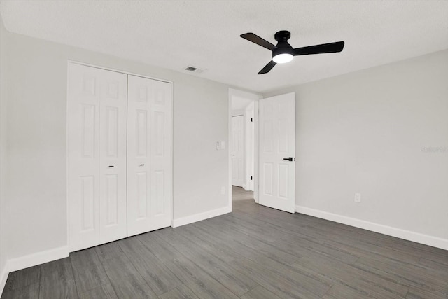 7835 Wallaba Ln, New Port Richey, FL 34653 - unfurnished bedroom featuring wood finished floors, a closet, and a ceiling fan