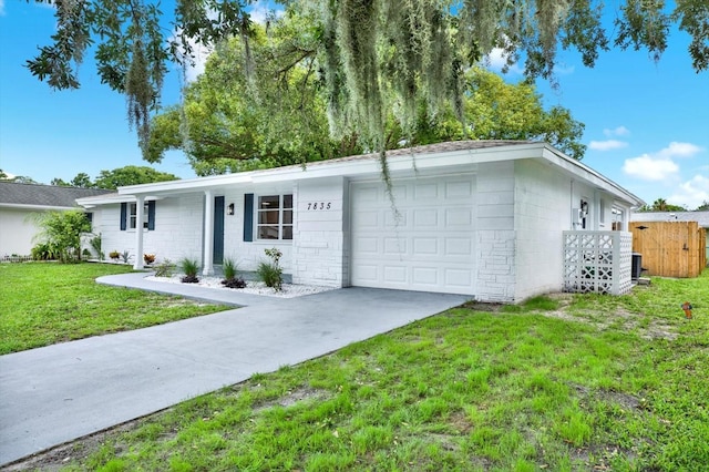 7835 Wallaba Ln, New Port Richey, FL 34653 - ranch-style house with concrete block siding, an attached garage, and concrete driveway