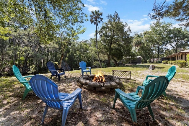 10584 N Dawnflower Pt, Crystal River, FL 34428 - view of green lawn with an outdoor fire pit and view of wooded area