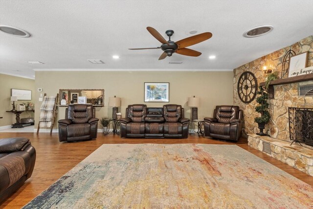 10584 N Dawnflower Pt, Crystal River, FL 34428 - living area with a stone fireplace, wood finished floors, ceiling fan, and crown molding