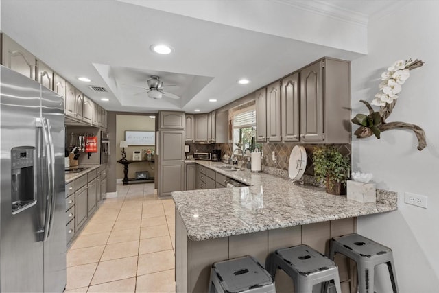 10584 N Dawnflower Pt, Crystal River, FL 34428 - kitchen with stainless steel fridge, a peninsula, a ceiling fan, light tile patterned floors, and gray cabinets