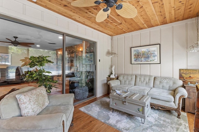 10584 N Dawnflower Pt, Crystal River, FL 34428 - living room featuring a ceiling fan, wood finished floors, wooden ceiling, and a decorative wall