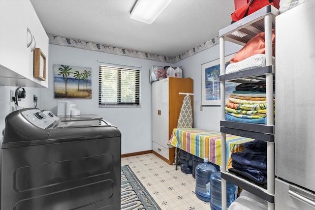 10584 N Dawnflower Pt, Crystal River, FL 34428 - laundry area featuring washing machine and clothes dryer, cabinet space, and tile patterned floors