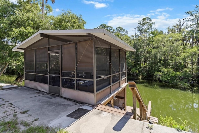 10584 N Dawnflower Pt, Crystal River, FL 34428 - view of outbuilding with a sunroom and a water view