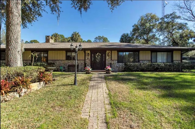 10584 N Dawnflower Pt, Crystal River, FL 34428 - ranch-style home featuring stone siding, a chimney, and a front yard