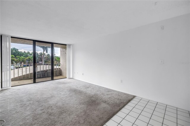 500 N Osceola Ave Unit 211, Clearwater, FL 33755 - tiled empty room with expansive windows and carpet