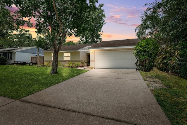 602 Timber Bay Cir W, Oldsmar, FL 34677 - view of front of home with concrete driveway, a yard, a garage, and stucco siding
