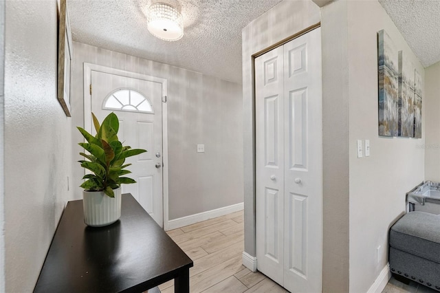 602 Timber Bay Cir W, Oldsmar, FL 34677 - entrance foyer with a textured ceiling and light wood-type flooring