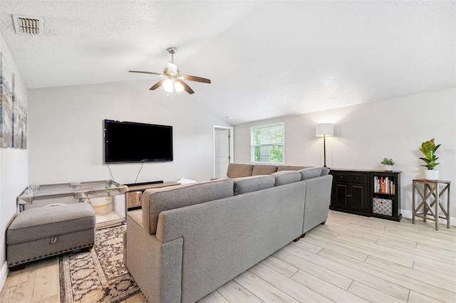 602 Timber Bay Cir W, Oldsmar, FL 34677 - living area with ceiling fan, vaulted ceiling, light wood finished floors, and a textured ceiling