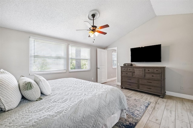 602 Timber Bay Cir W, Oldsmar, FL 34677 - bedroom with lofted ceiling, a textured ceiling, light wood-style floors, and ceiling fan