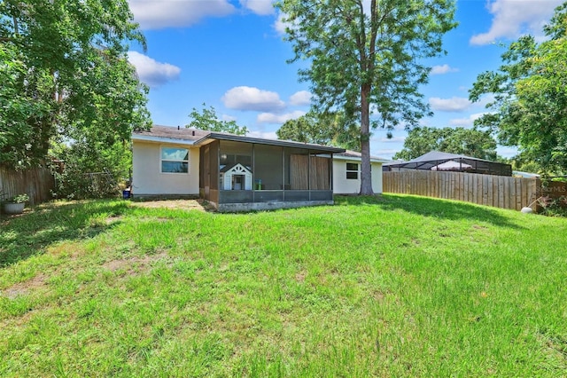 602 Timber Bay Cir W, Oldsmar, FL 34677 - back of house featuring a sunroom, a fenced backyard, and stucco siding