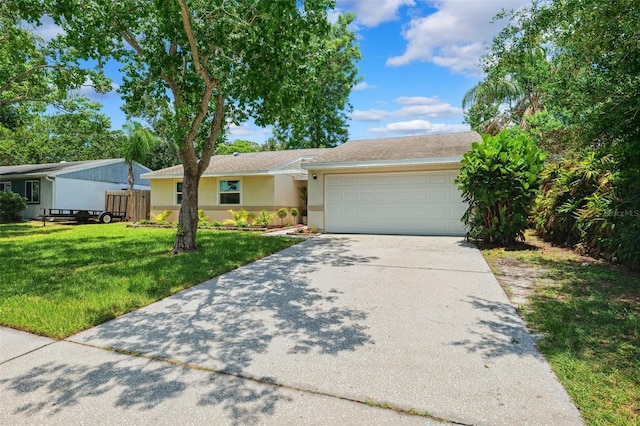 602 Timber Bay Cir W, Oldsmar, FL 34677 - ranch-style house with a garage, concrete driveway, stucco siding, and a front yard