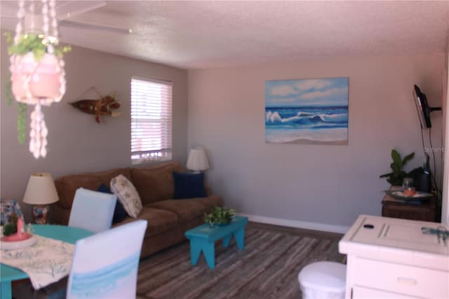 6800 Sunset Way Unit 1708, St Pete Beach, FL 33706 - living room with wood finished floors and a textured ceiling