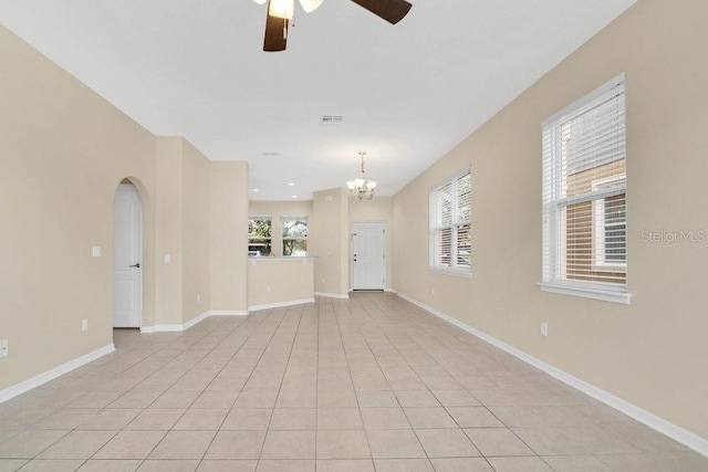12975 Calderdale Ave, Windermere, FL 34786 - spare room featuring ceiling fan, a chandelier, arched walkways, and light tile patterned floors