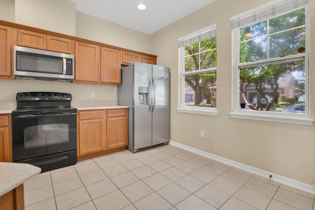 12975 Calderdale Ave, Windermere, FL 34786 - kitchen with appliances with stainless steel finishes, light countertops, brown cabinets, light tile patterned floors, and recessed lighting