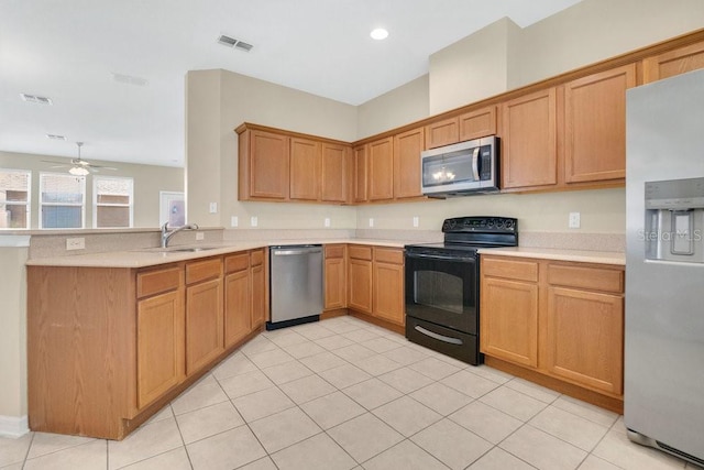 12975 Calderdale Ave, Windermere, FL 34786 - kitchen with stainless steel appliances, light countertops, a peninsula, a ceiling fan, and light tile patterned flooring