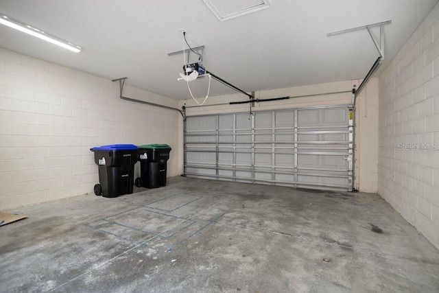12975 Calderdale Ave, Windermere, FL 34786 - garage featuring concrete block wall and a garage door opener
