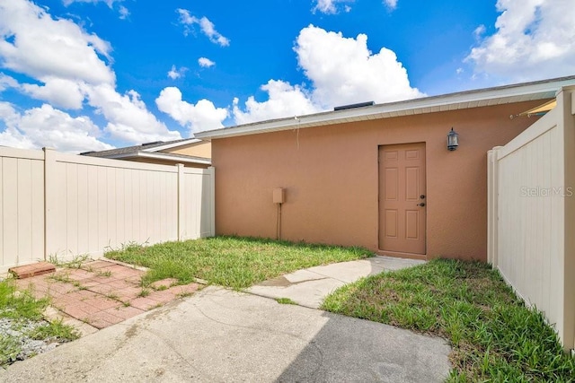 12975 Calderdale Ave, Windermere, FL 34786 - view of exterior entry with stucco siding