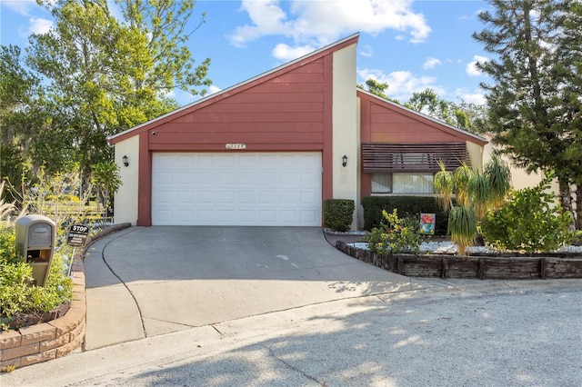 12234 Cider Mill Ln, Hudson, FL 34667 - mid-century modern home with concrete driveway, an attached garage, and stucco siding
